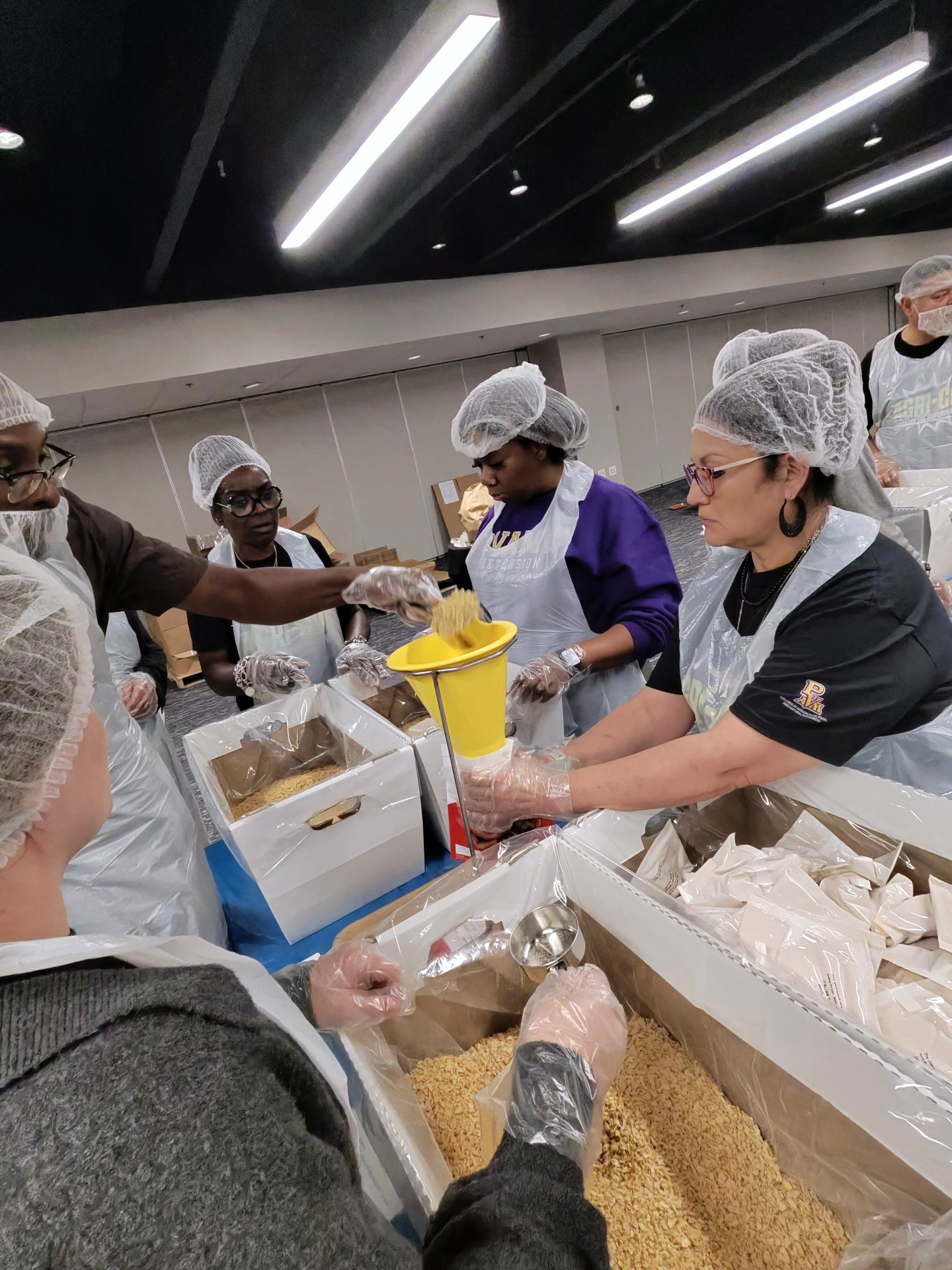 PVAMU Extension volunteers on the pasta line