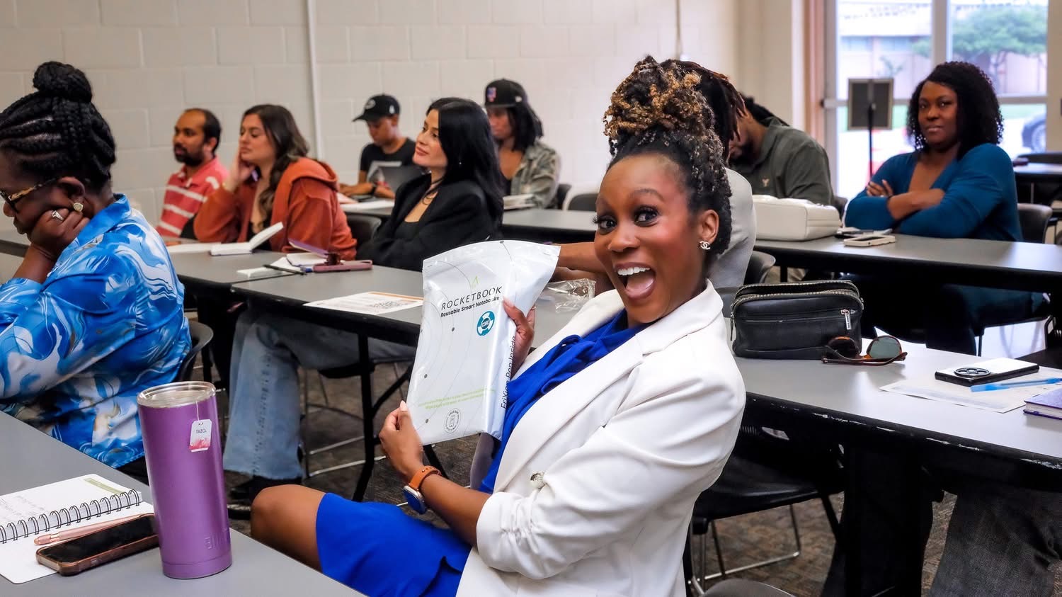 Founder smiling with a Rocketbook notebook at B.I.D.