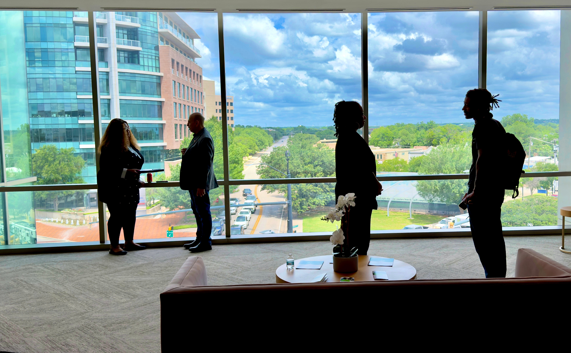 Founders in silhouette against the downtown skyline